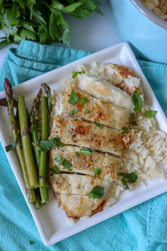 overhead shot of sliced chicken breast with asparagus and rice