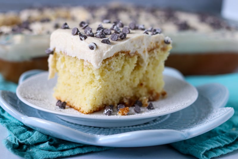 white cake topped with cannoli filling and mini chocolate chips