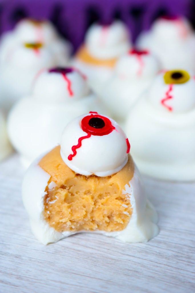 peanut butter balls dipped in white chocolate and topped with a candy eyeball