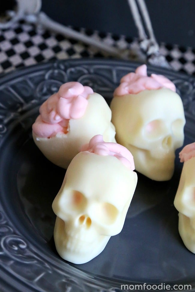 white chocolate skulls with pink "brains" frosting coming out