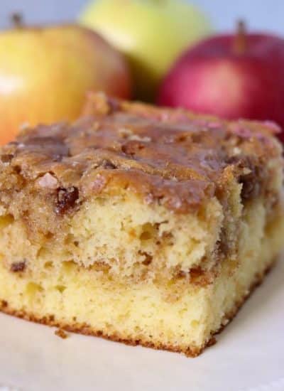 slice of honey bun cake surrounded by apples