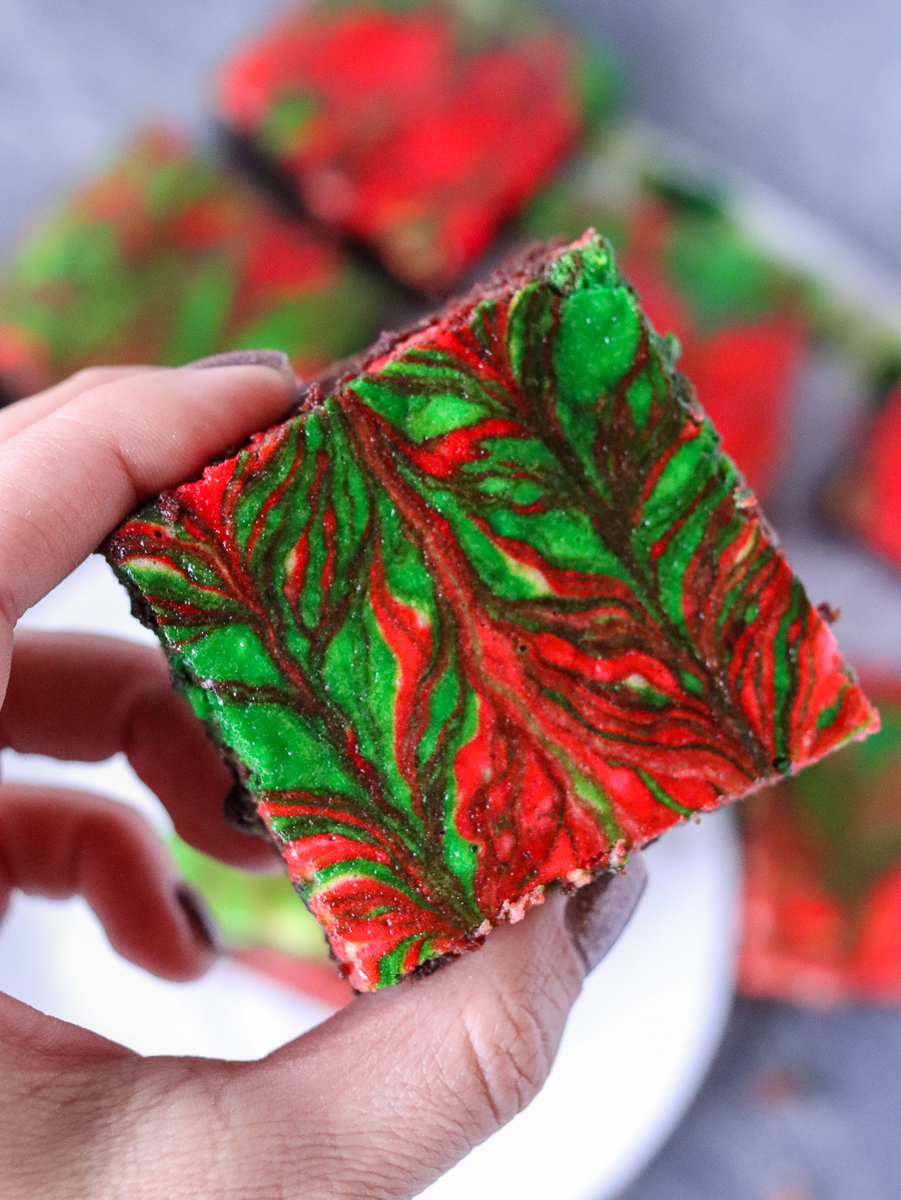 hand holding a red & green swirled christmas brownie