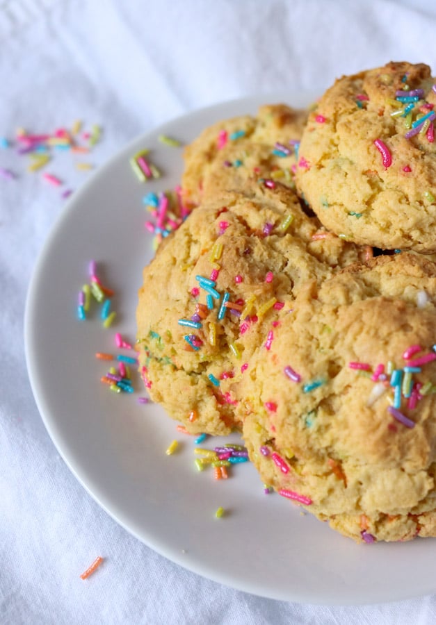 plates of cream cheese sprinkle cookies with rainbow colored sprinkles