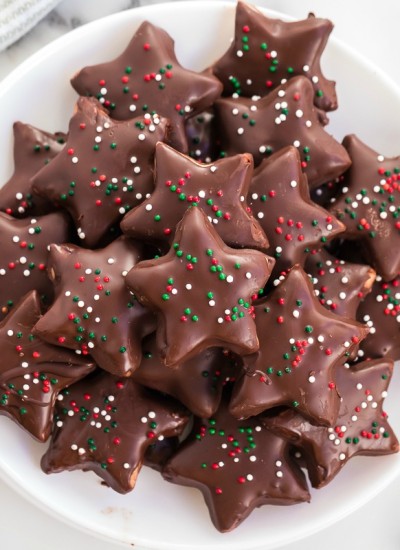 platter of shortbread cookies coated in chocolate with christmas sprinkles