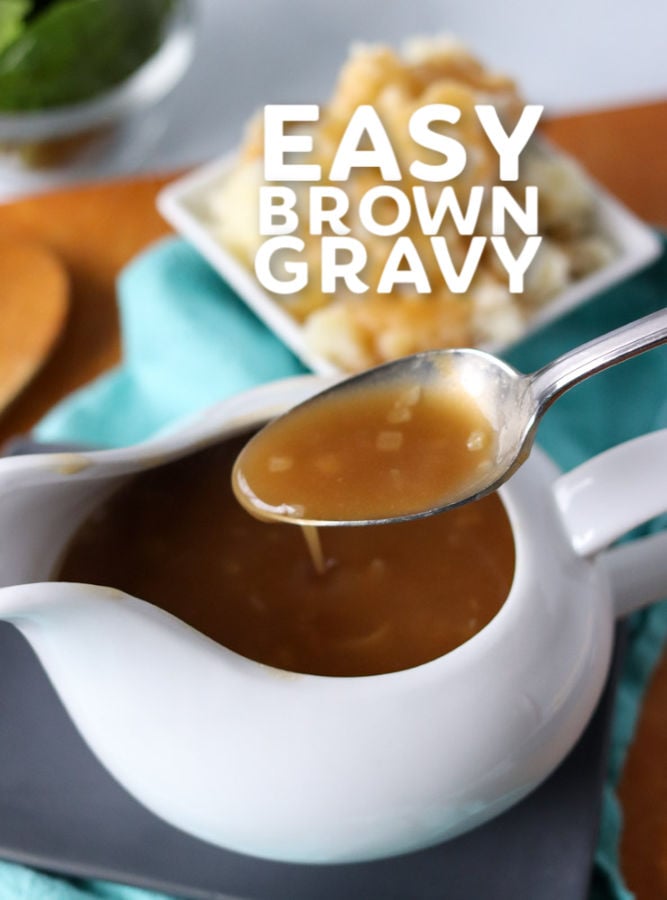 gravy on a spoon over a gravy boat