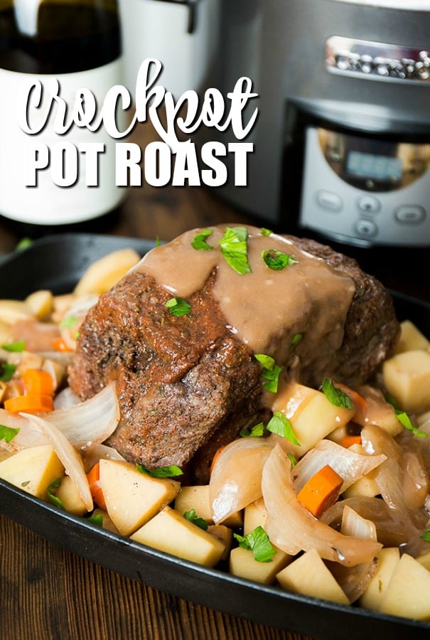 crockpot pot roast surrounded by veggies on a platter