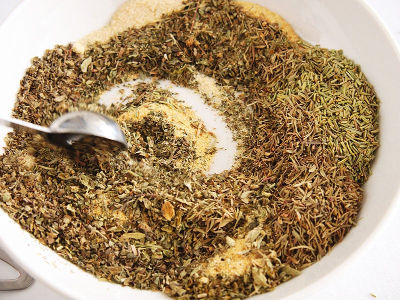 spices being mixed in a bowl