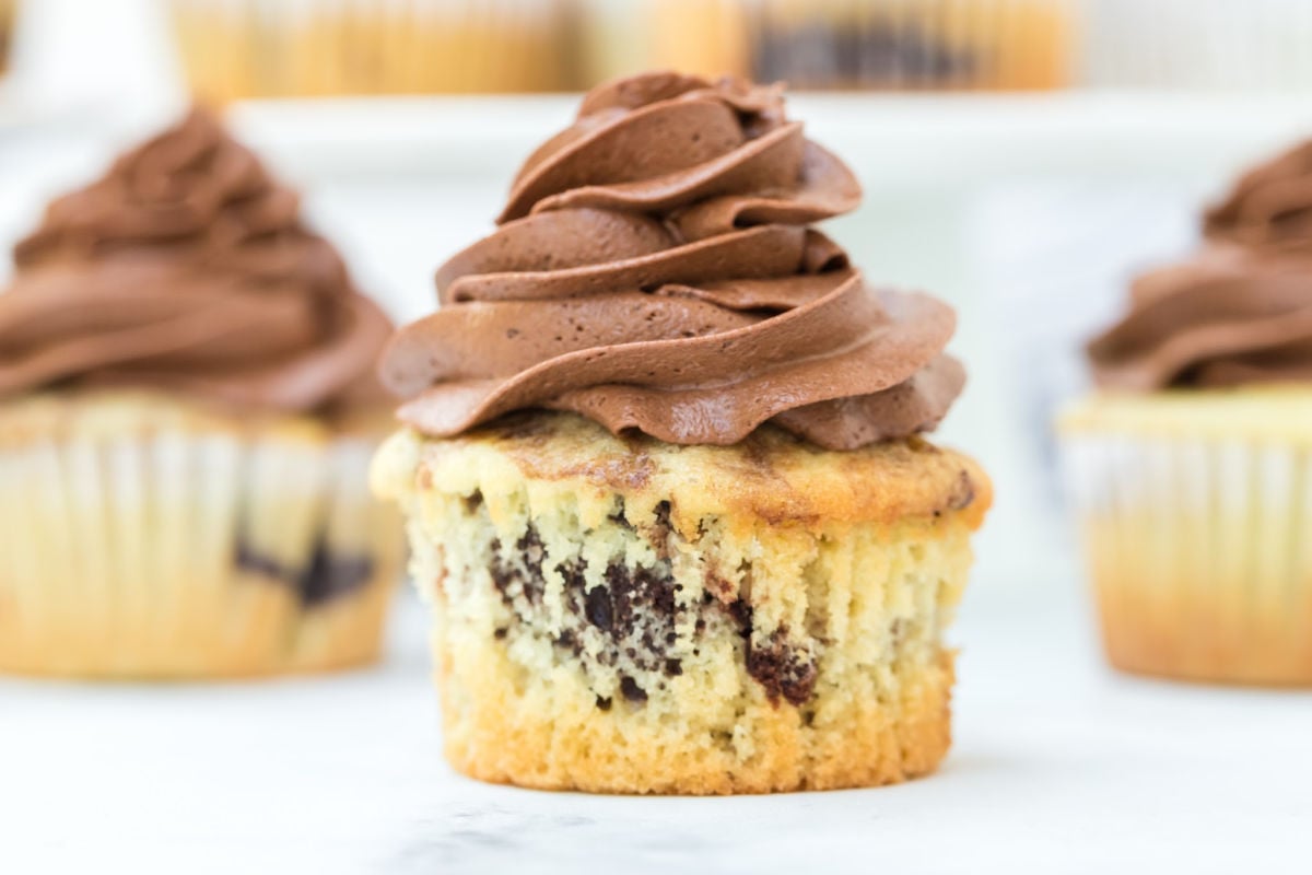 three cupcakes with chocolate frosting