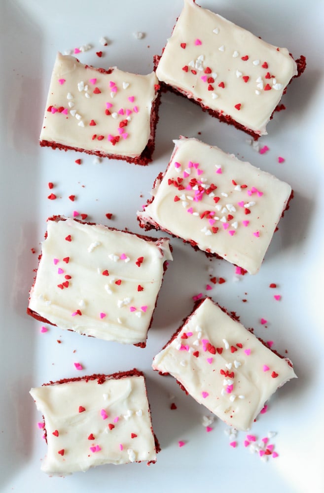 white plate of cookie bars topped with valentine sprinkles