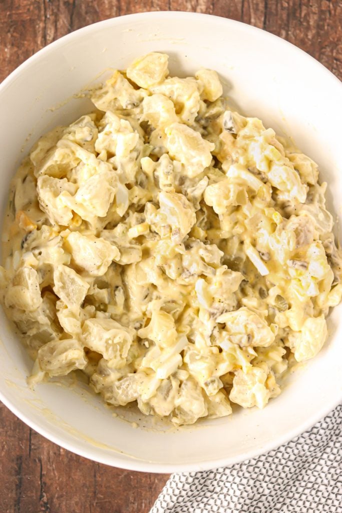 overhead shot of potato salad in large white bowl