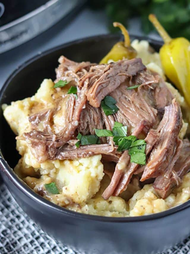 close up on bowl of mississippi pot roast over mashed potatoes