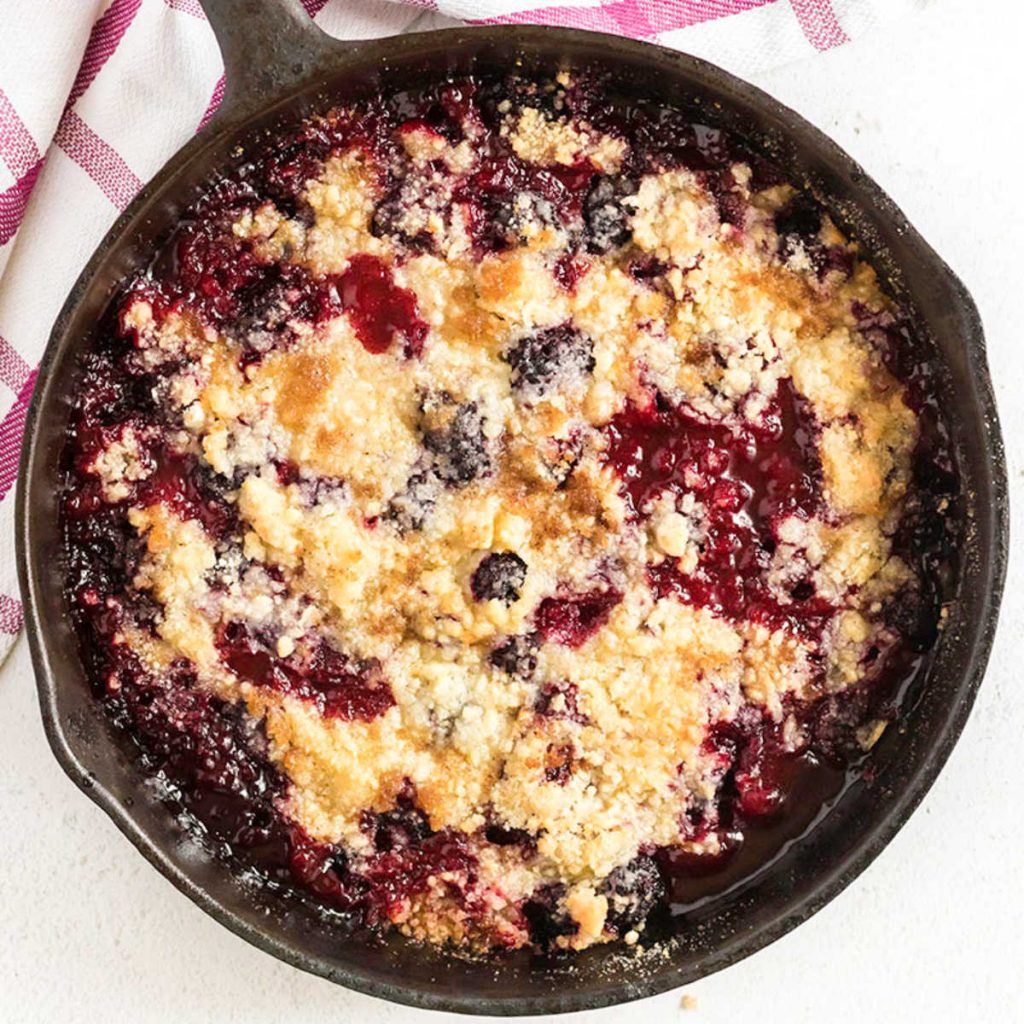 overhead shot of blackberry crumble in a cast iron skillet.