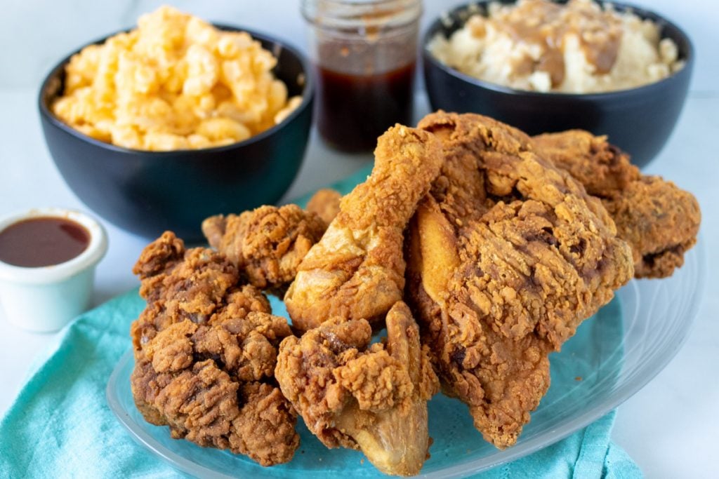 plate of fried chicken in front of macaroni and mashed potatoes