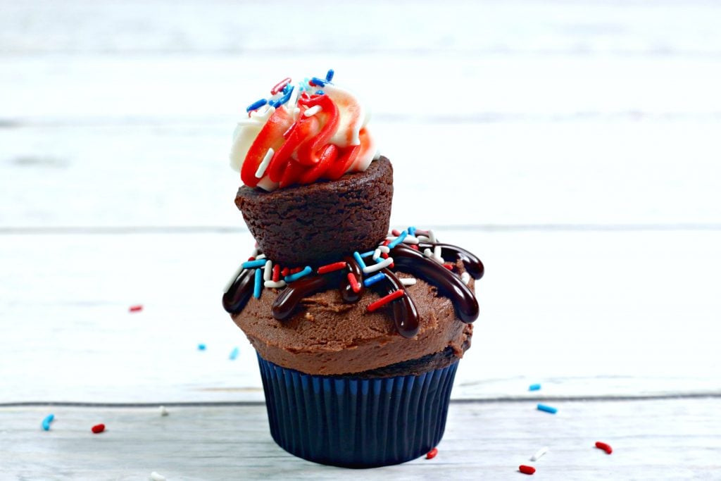 single chocolate cupcake topped with a mini brownie