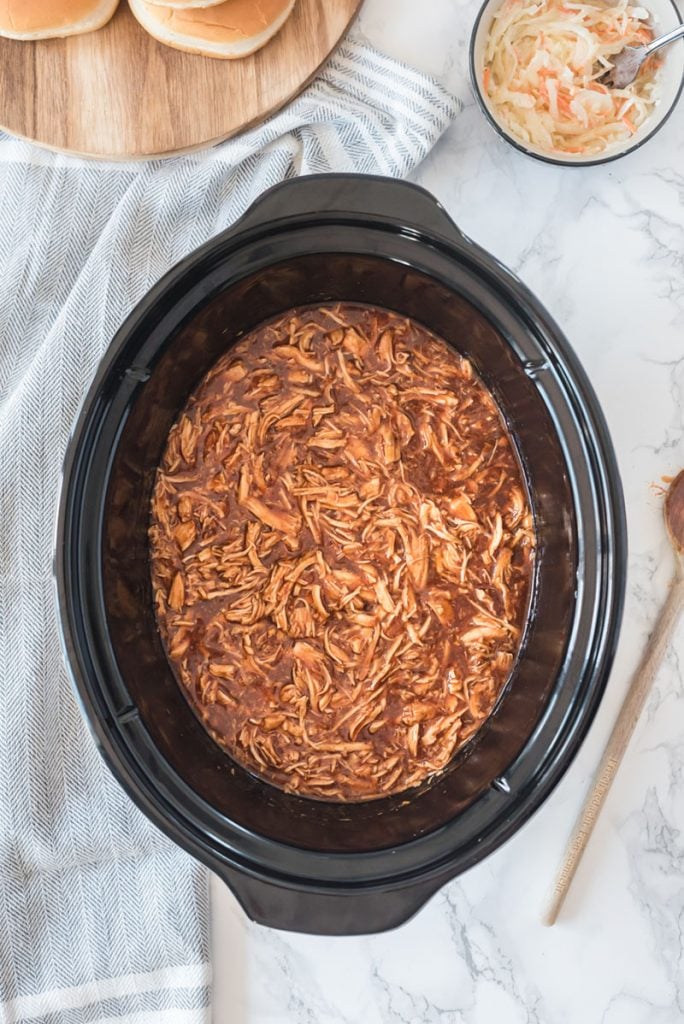overhead shot of pulled chicken in slow cooker