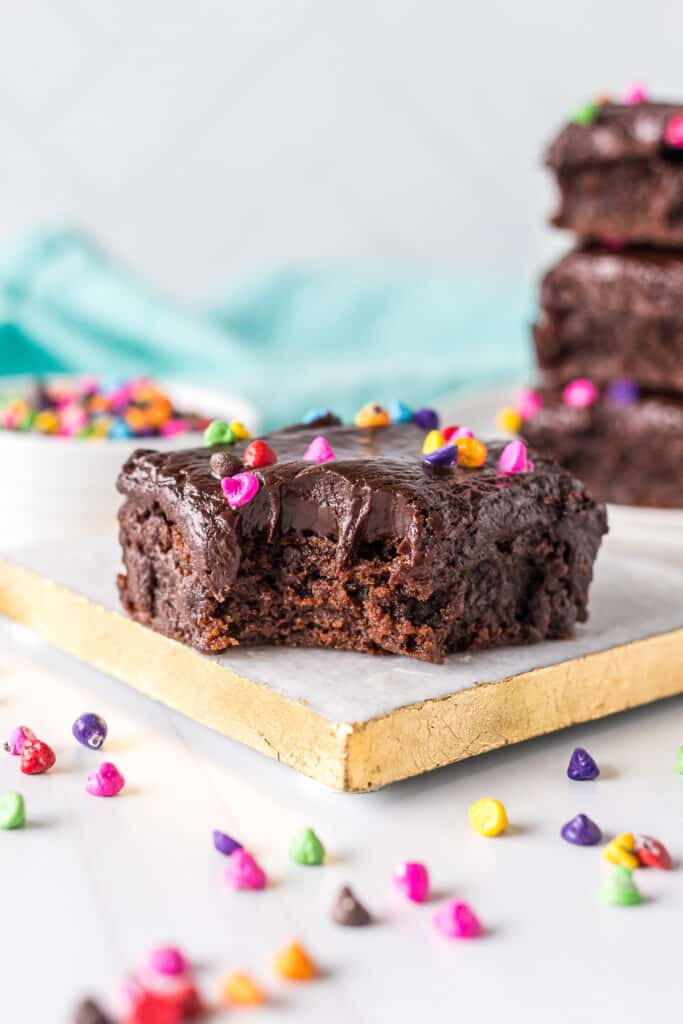 brownie topped with sprinkles with a bite missing.