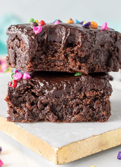 stack of two cosmic brownies with a bite missing from the top one.