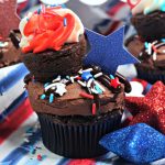 close up of chocolate cupcake with red white & blue sprinkles