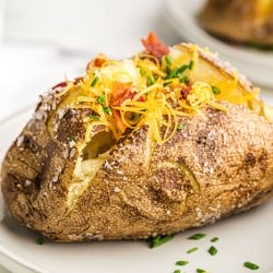 loaded baked potato topped with cheese & bacon & chives