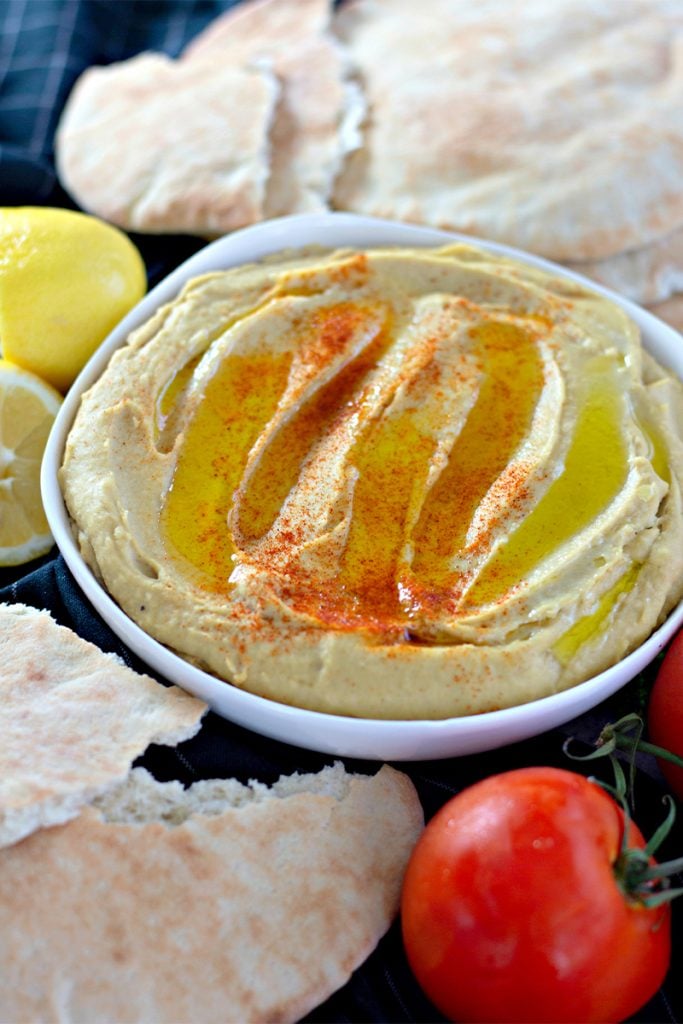 closeup of hummus drizzled with olive oil & sprinkled with paprika