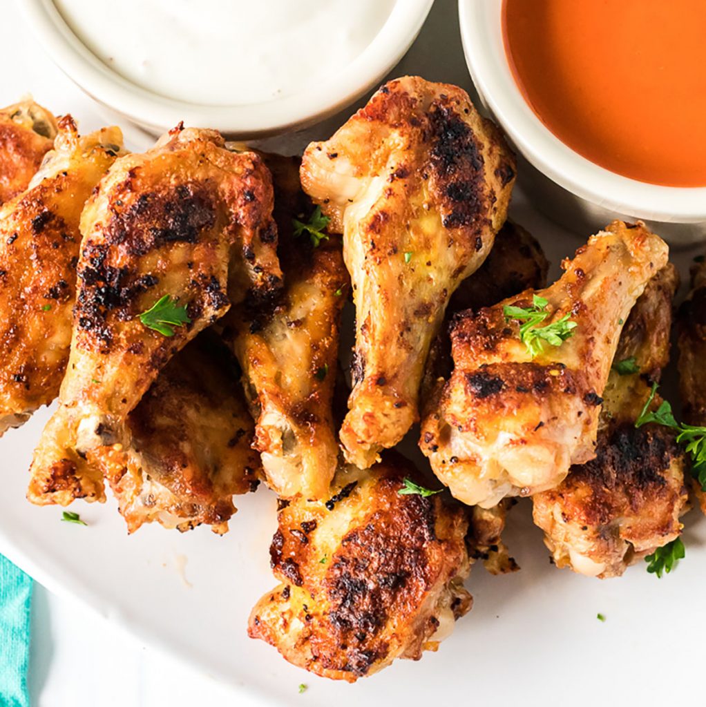 plate of air fryer chicken wings with bleu cheese & buffalo sauce cups