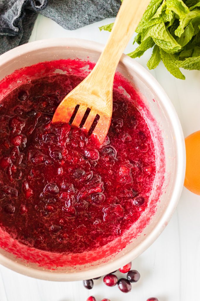 saucepan of cranberry sauce with wooden spoon