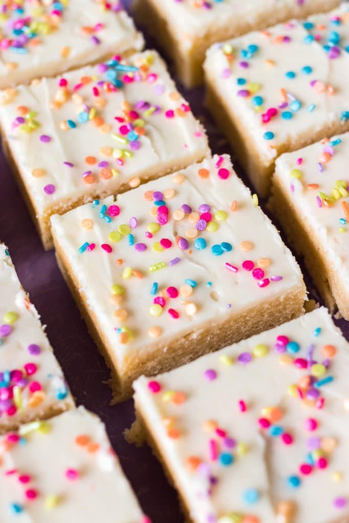 overhead shot of sliced sugar cookie bars topped with sprinkles.