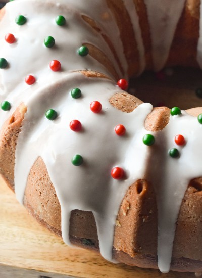 bundt cake drizzled with icing & topped with red & green sprinkles