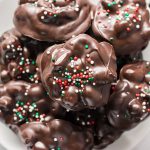 stack of chocolate peanut clusters with christmas sprinkles