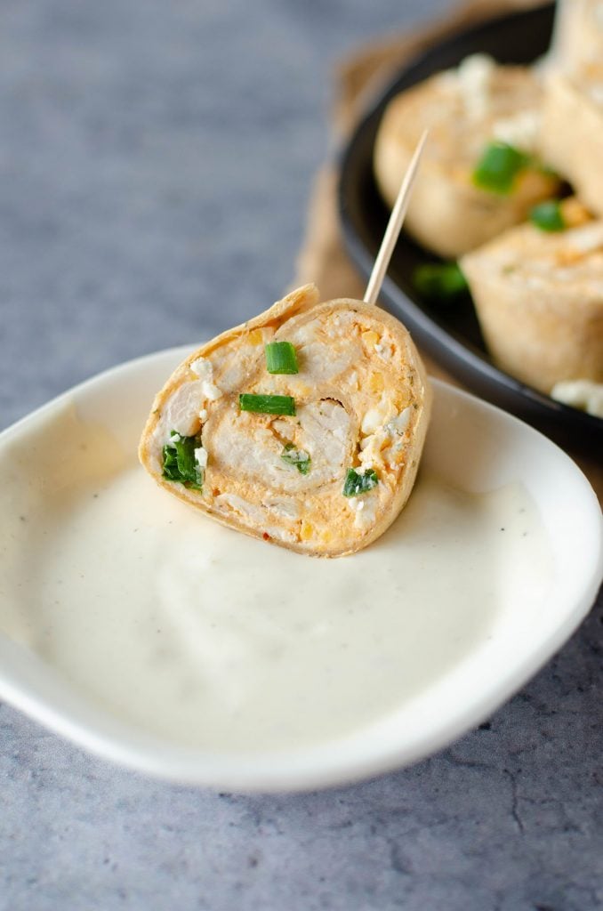 chicken rollup dipping into ranch dressing