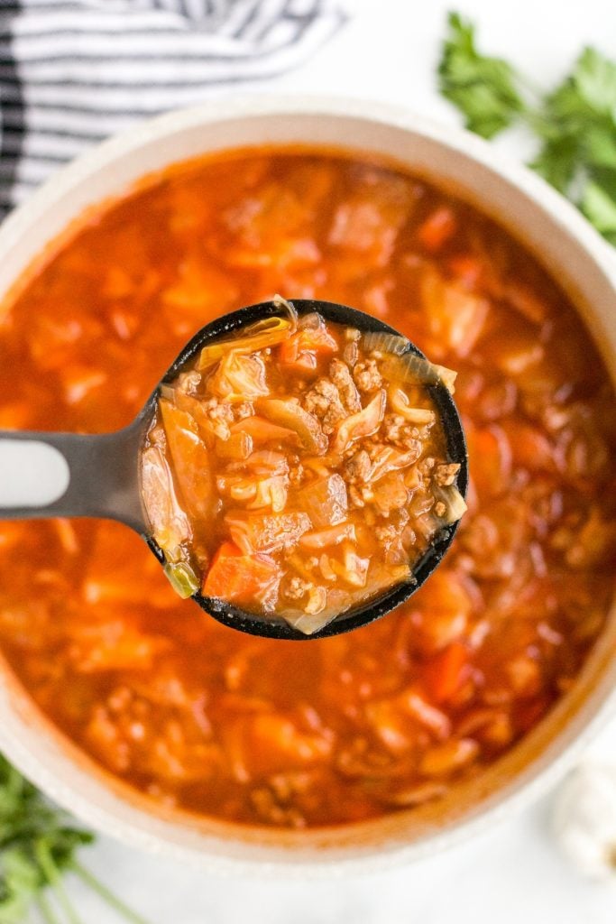 spoon of cabbage roll soup over a bowl