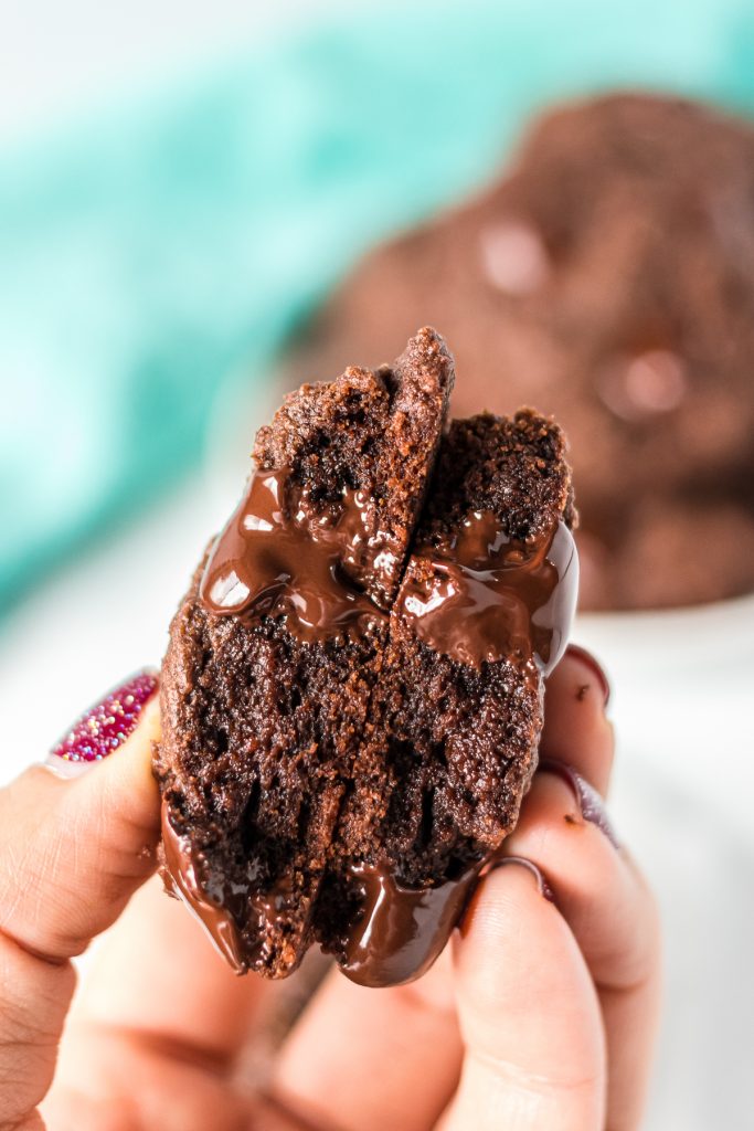 hand holding a double chocolate cookie with melty chocolate