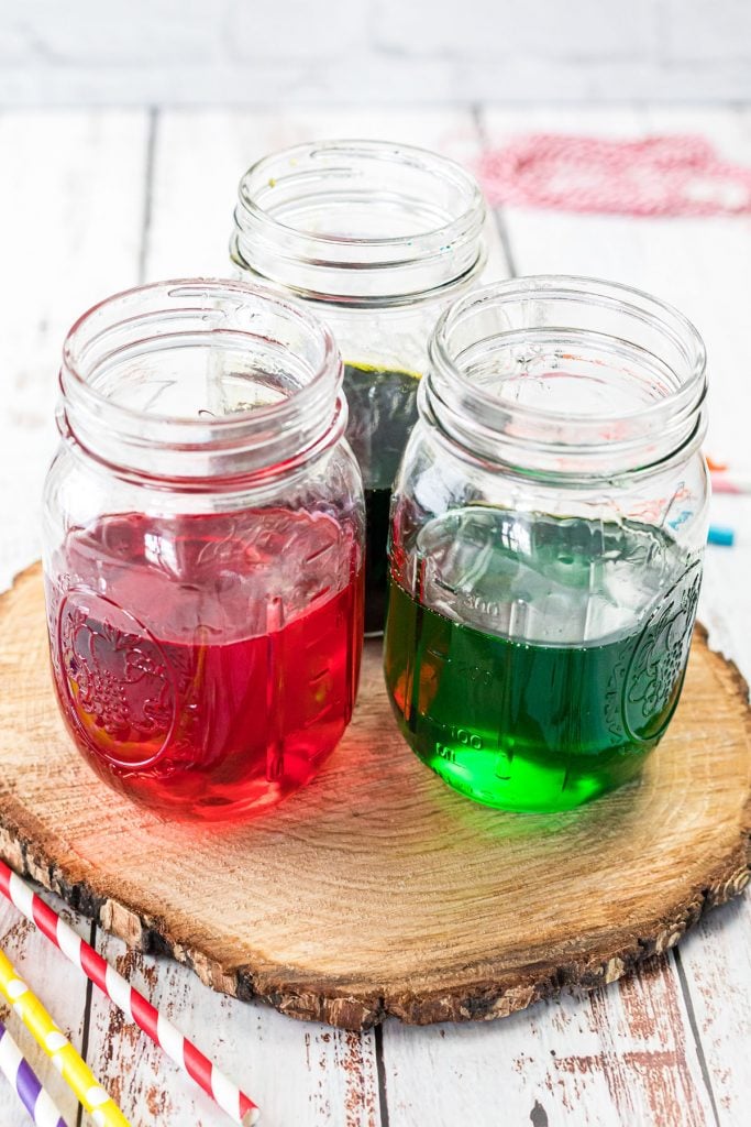 three mason jars filled with red and green liquid