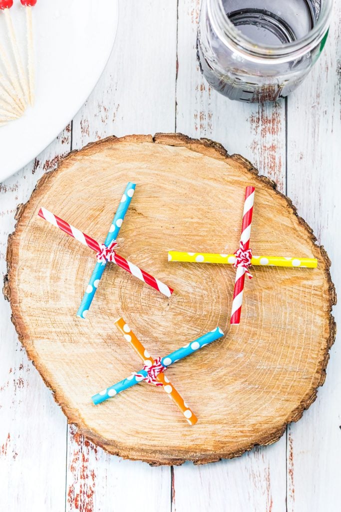 colorful straws tied into X shapes with twine