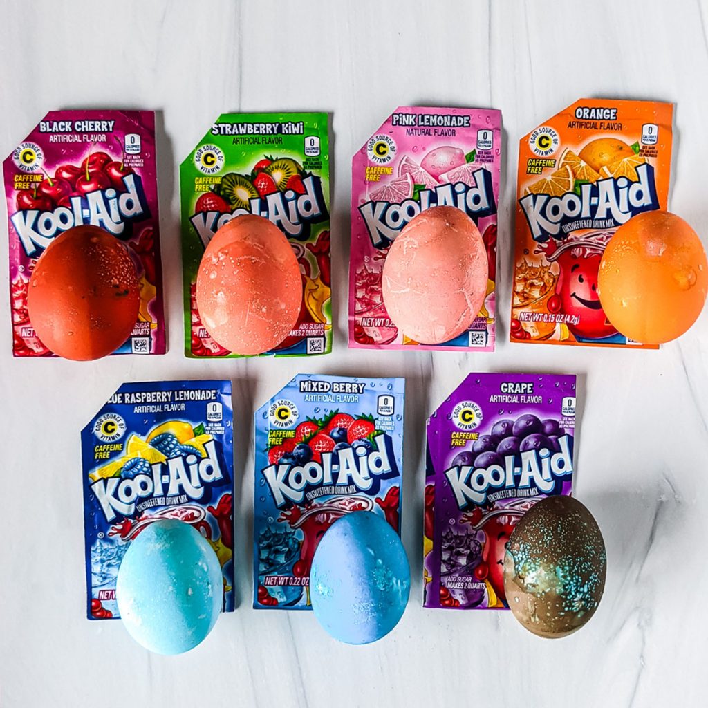 kool-aid packets with dyed eggs showing colors