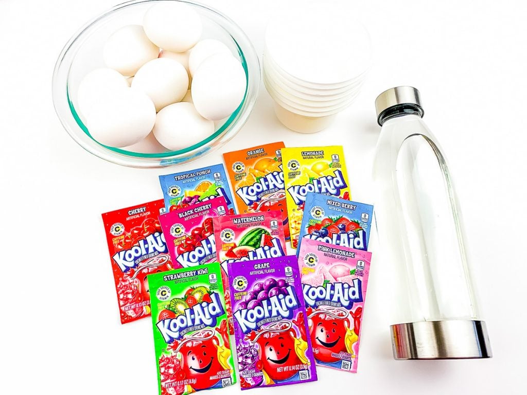 kool-aid packets, water, and eggs laid out to color eggs