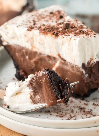 slice of chocolate pudding pie with a bite on a fork next to it
