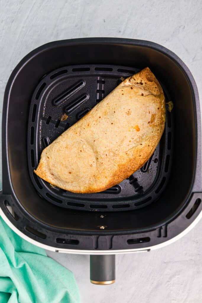 overhead shot of a toasted quesadilla in an air fryer.