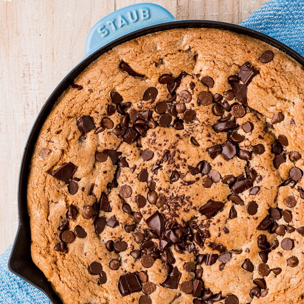 overhead shot of a chocolate chip skillet cookie on a blue napkin