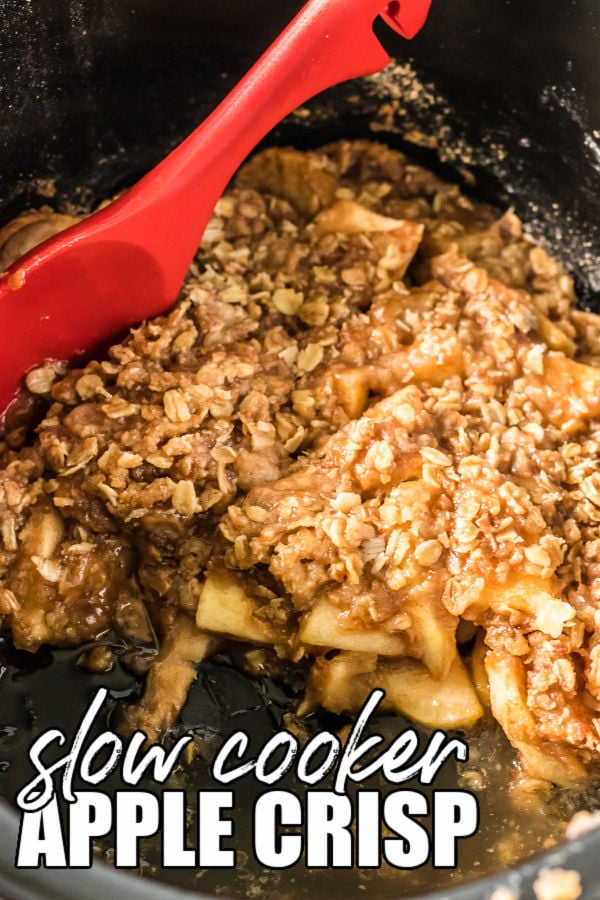 apple crisp in a slow cooker with a red spoon taking out a scoop