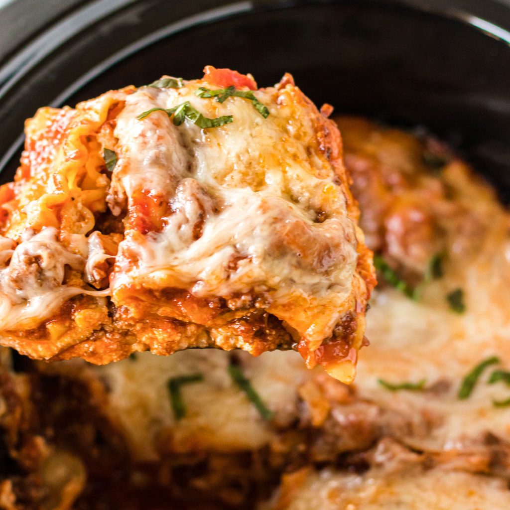 slice of lasagna being lifted from the slow cooker