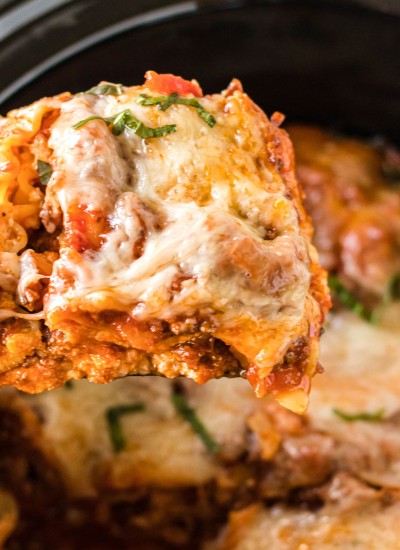 slice of lasagna being lifted from the slow cooker