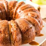 side view of an autumn spice bundt cake dripping with caramel