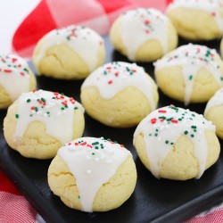 italian sugar cookies with christmas sprinkles on a black platter