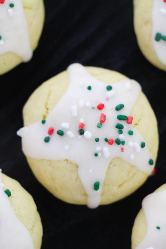 closeup shot of a cookie with icing and christmas sprinkles