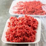 red velvet rice krispies on a white tray that look like raw meat
