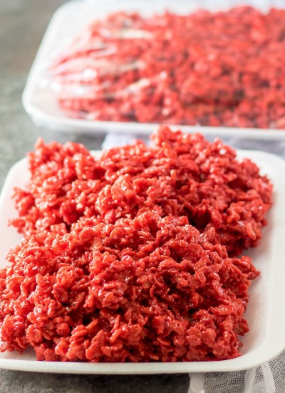 red velvet rice krispies on a white tray that look like raw meat