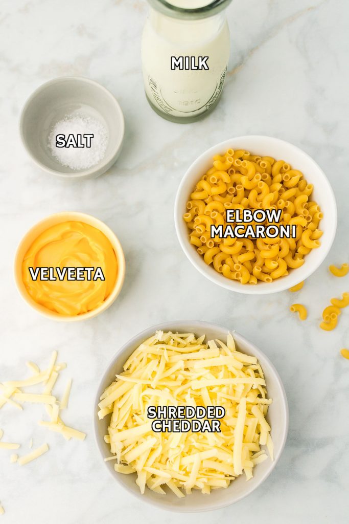 overhead shot of labeled ingredients laid out to make 3 ingredient mac and cheese - cheese, milk, noodles