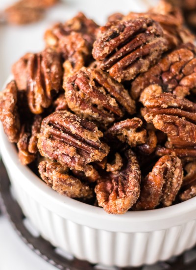 closeup shot of candied pecans in a white bowl
