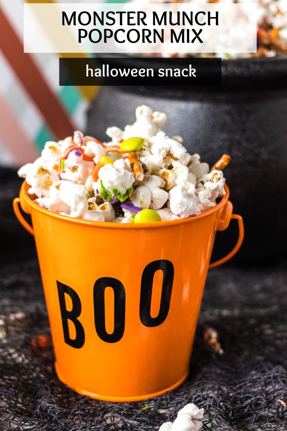 Halloween Monster Munch Popcorn Mix is a super easy party treat made with popcorn, pretzels, and Halloween candy that is drizzled with colorful vanilla candy melts. It's a perfect blend of salty, sweet, and delicious for a fun Halloween snack. | www.persnicketyplates.com